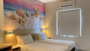 A hotel room with two beds, a painting of sea creatures on the wall, and a large window. - Cordela Hotel Pangkal Pinang (Pangkalpinang)