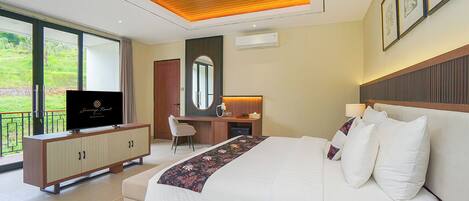 A modern hotel room with a large bed, a desk, and a television.
