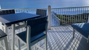 A deck with a table and chairs overlooking the ocean. - Seamist #6-Oceanfront-Wonderful View! (Seacrest)
