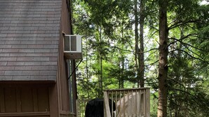 A wooden cabin with a gravel driveway and a wooden staircase leading to a deck. - Chalet with Hot Tub & Pet Friendly (Summersville)