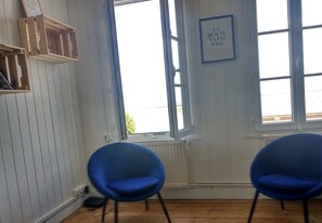 Relax in a cozy space with a window seat, comfortable chairs, and a warm radiator.