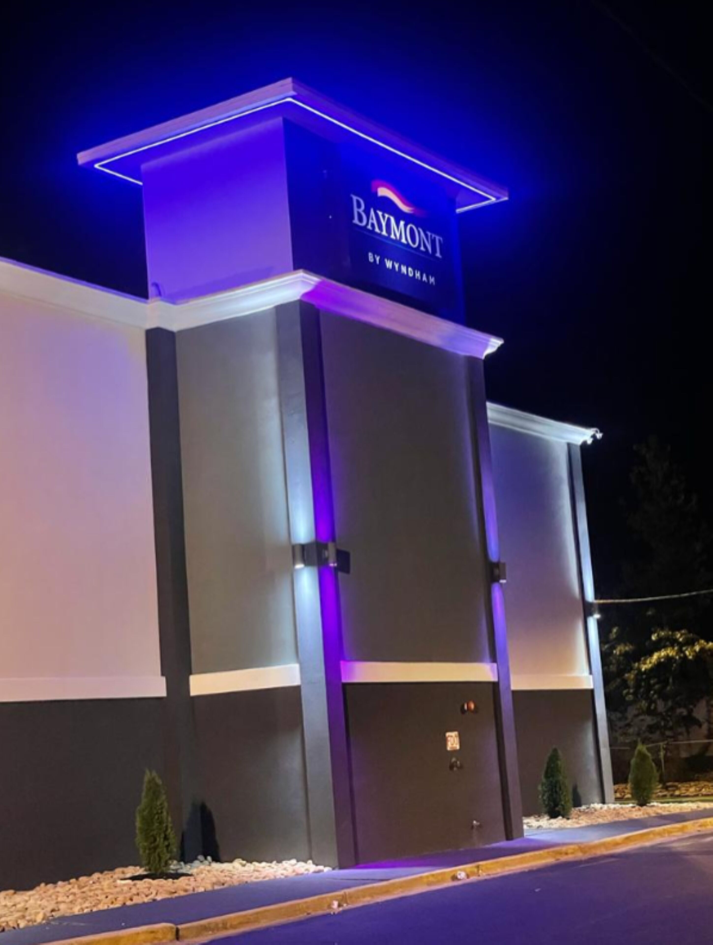 A hotel entrance with a prominent sign reading "Baymont by Wyndham."