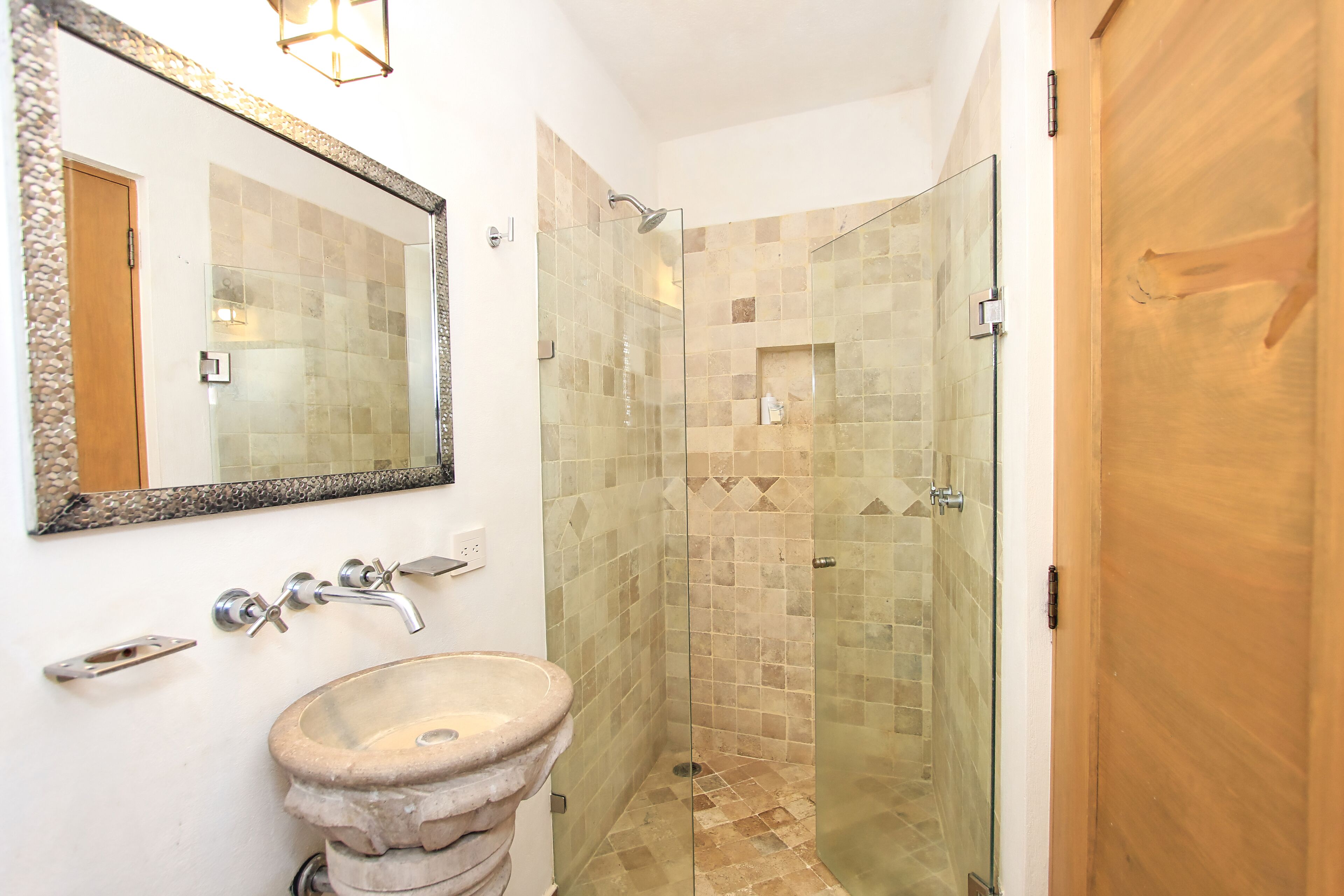 deluxe room | bathroom | shower, rainfall showerhead, hair dryer, towels