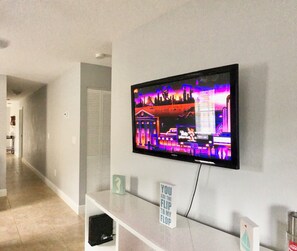 Relax in this stylish living room with a flat-screen TV and a unique console below.
