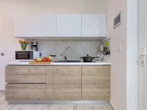 Fridge, microwave, cookware/dishes/utensils, dining tables
