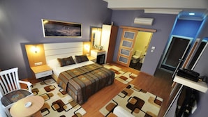 A bedroom with a bed, bedside tables, a desk, a chair, and a TV. - Khalkedon Hotel Istanbul (Istanbul)