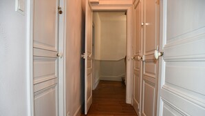 A narrow hallway with white doors and wooden flooring. - Maison bourgeoise Haussmannienne (Gîtes de France) (Limoges)
