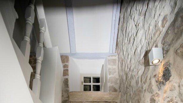 A narrow staircase with white steps leading to a stone wall. - Rooms Epidaurus (Dubrovnik)