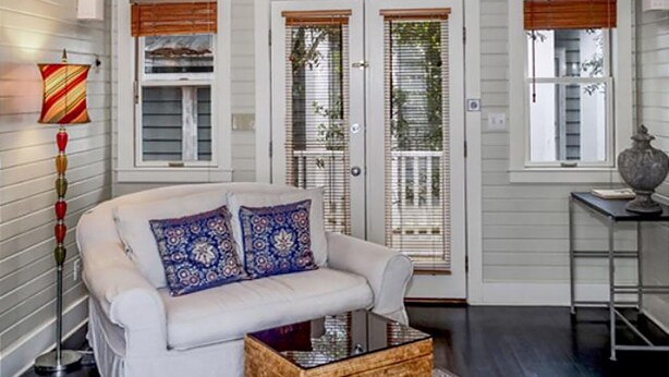 A white sofa with patterned cushions, a wooden coffee table, and a lamp. - Turkish Delight in Seaside (Santa Rosa Beach)