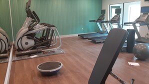 A gym with exercise equipment, including treadmills and a stationary bike, and a mirror reflecting the space. - Holiday Inn Express & Suites Harrisburg S - Mechanicsburg by IHG (Mechanicsburg)