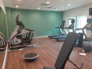 A gym with exercise equipment, including treadmills and a stationary bike, and a mirror reflecting the space. - Holiday Inn Express & Suites Harrisburg S - Mechanicsburg by IHG (Mechanicsburg)