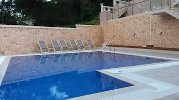 Seasonal outdoor pool, open 10:00 AM to 8:00 PM, pool umbrellas