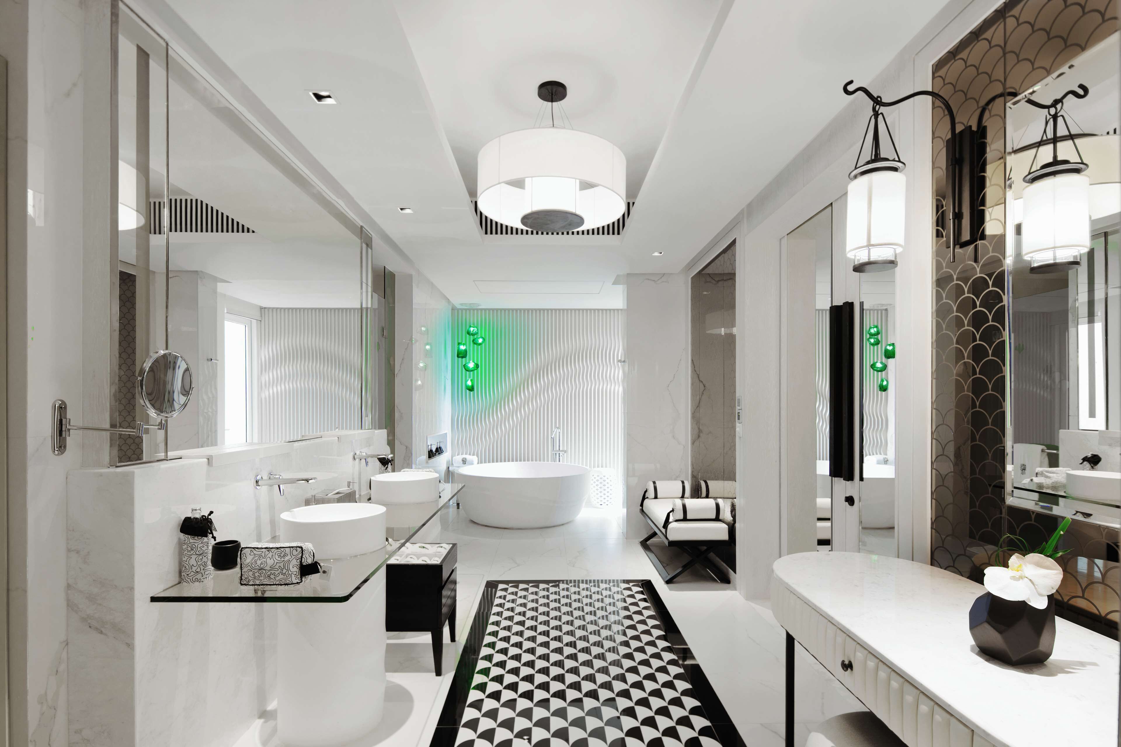 A modern bathroom with a freestanding bathtub, a large mirror, and a glass shower enclosure.