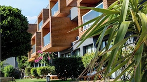 A modern multi-story building with wooden paneling and large windows. - Palmalife Bodrum Resort & Spa (Bodrum)