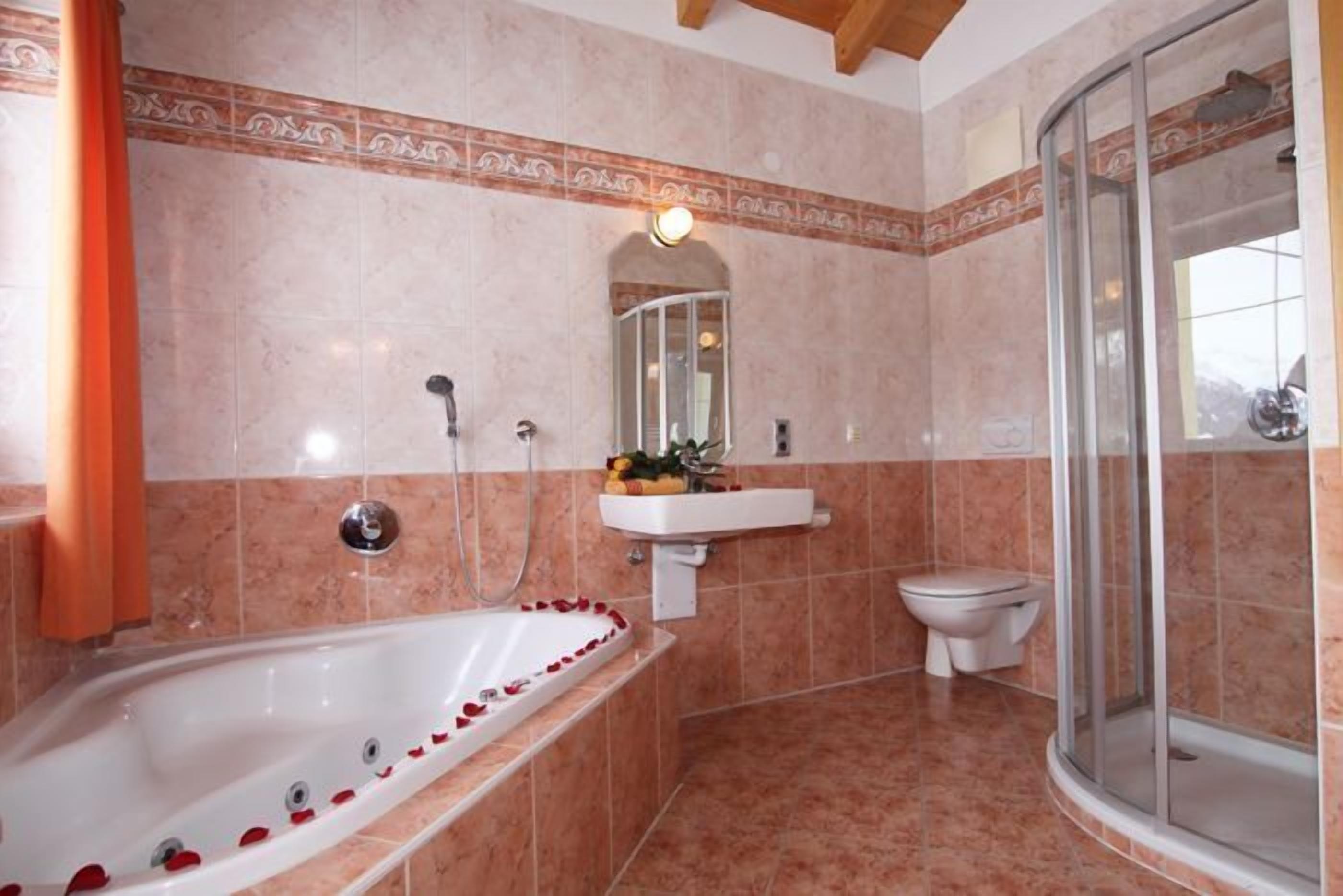 junior suite | bathroom | jetted bath, rainfall showerhead, hair dryer, towels