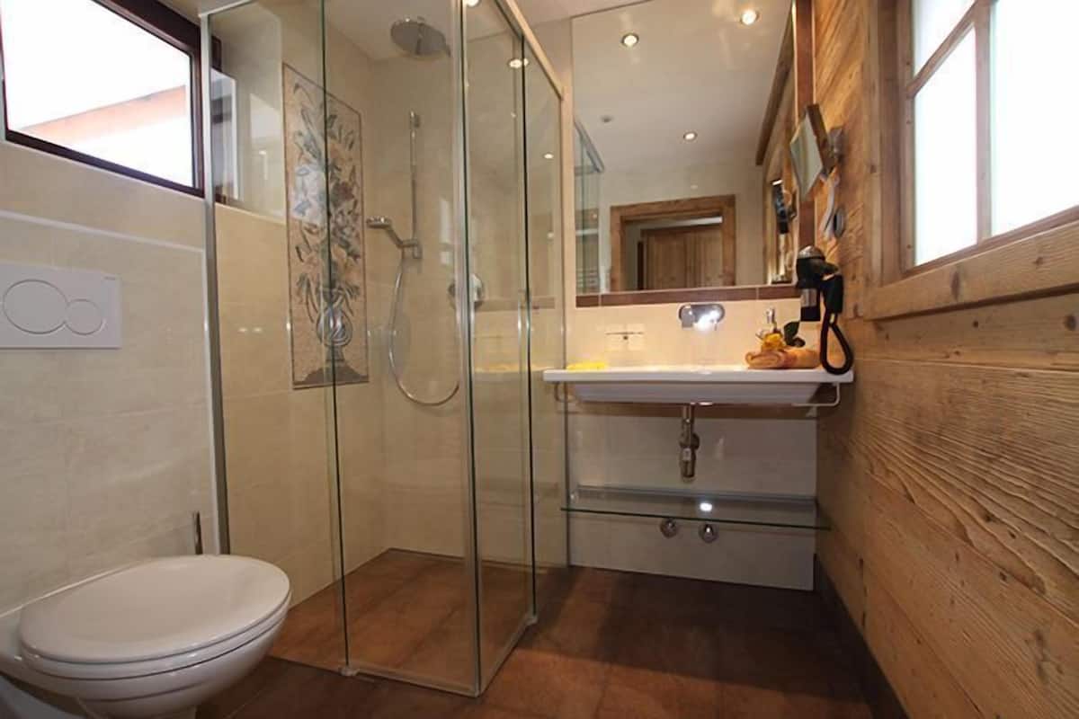 superior double room | bathroom | jetted bath, rainfall showerhead, hair dryer, towels
