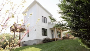 A two-story white house with a covered porch, a small deck, and a grassy yard. - Eco- Friendly house near UNCA and downtown AVL, Mountain Views  (Asheville)