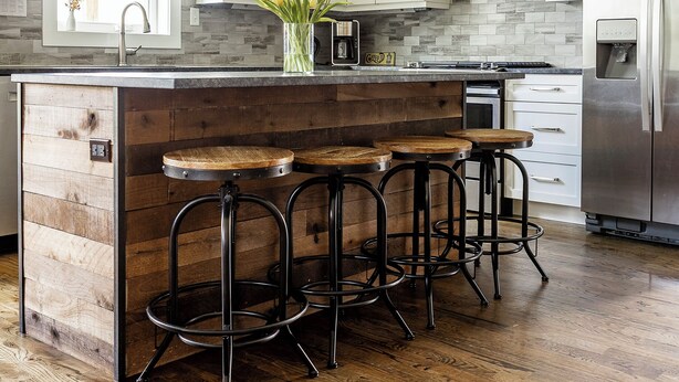 A modern kitchen with a central island, bar stools, pendant lights, and a stainless steel refrigerator. - Eco- Friendly house near UNCA and downtown AVL, Mountain Views  (Asheville)