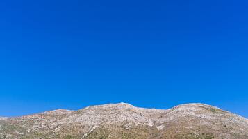 A mountain with a clear blue sky.