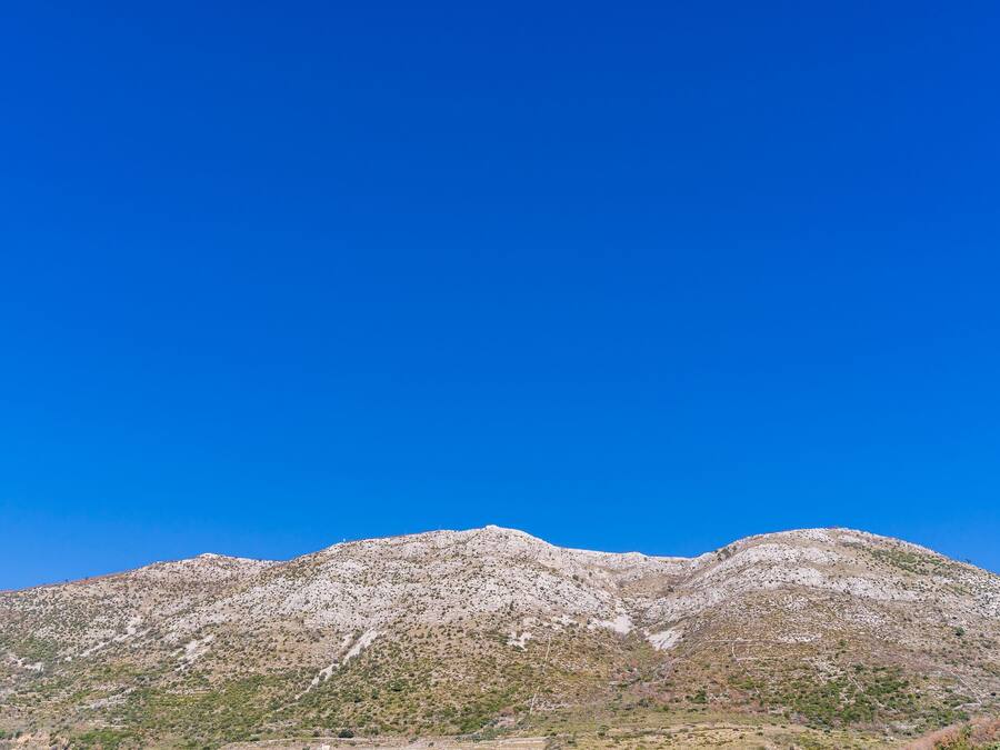 A mountain with a clear blue sky.