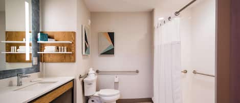 Un baño moderno con tocador, inodoro y ducha.