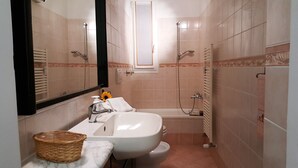 A bathroom with a sink, mirror, and shower. - Casa Vicki (Genoa)