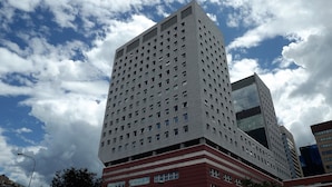 A high-rise building with a grid of windows and a modern architectural design. - House Asfodelo (Genoa)