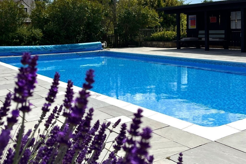 Una piscina al aire libre, una piscina climatizada