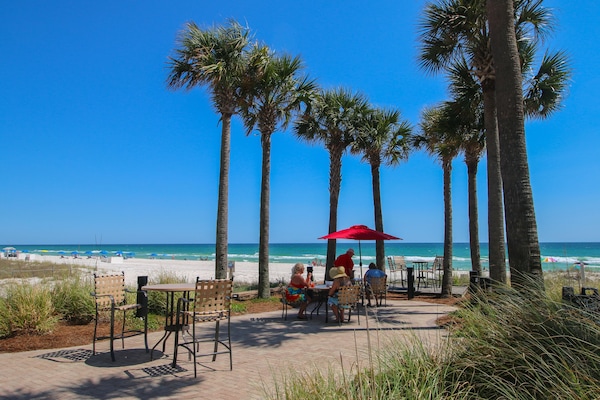 Dining tables beside tiki bar