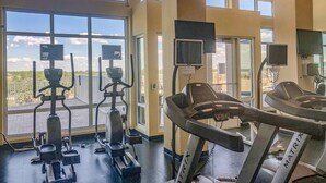 A gym with treadmills, elliptical machines, and stationary bikes. - L👀K!!! ⭐️ TOP RATED CONDO ⭐️ 3 Pools ⭐️ Breathtaking Ocean Views !!! (Panama City Beach)