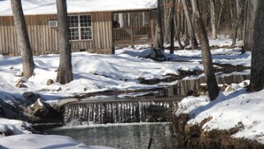 A cabin with a wooden exterior, a window, and a balcony. - Lazy G Cabin #4 Creeks Edge (Union Grove)