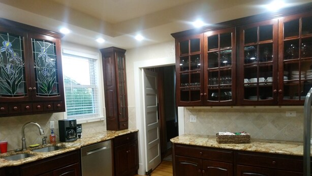 A kitchen with wooden cabinets, a stainless steel dishwasher, and a granite countertop. - Governor's Home (Historic Property) (Cheyenne)