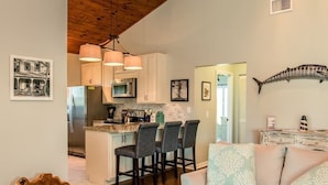 A modern kitchen with a central island, bar stools, and pendant lighting. - FALL SEASON 55% OFF RENTAL RATE (Marathon)
