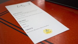 A menu on a wooden table.