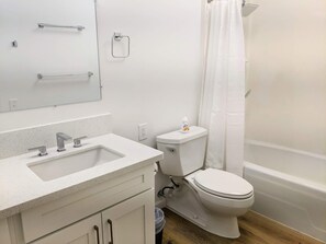 Combined shower/bathtub, towels, soap, shampoo