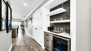A modern kitchen with white cabinetry, a built-in oven, and a wine rack. - Centre Ridge Escape | 3BR Modern Condo w/ Golf Course Views in Reunion Resort Near Disney (Kissimmee)