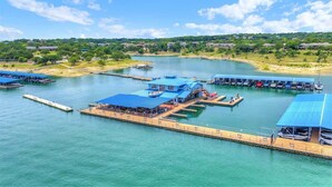 Un port de plaisance avec des bateaux amarrés, un espace de repos abrité et une vue sur le paysage environnant.