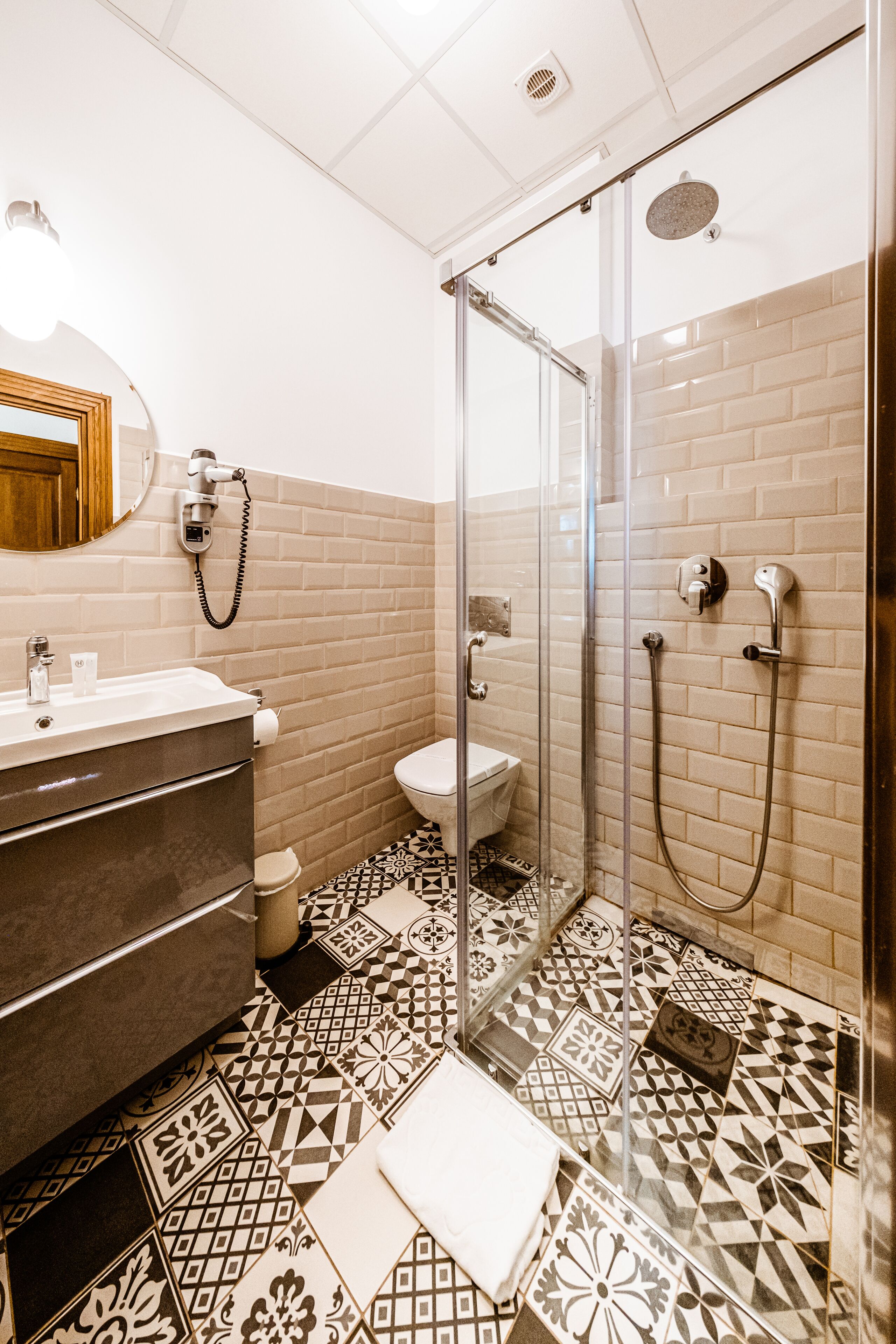 A bathroom with a shower, toilet, and sink.
