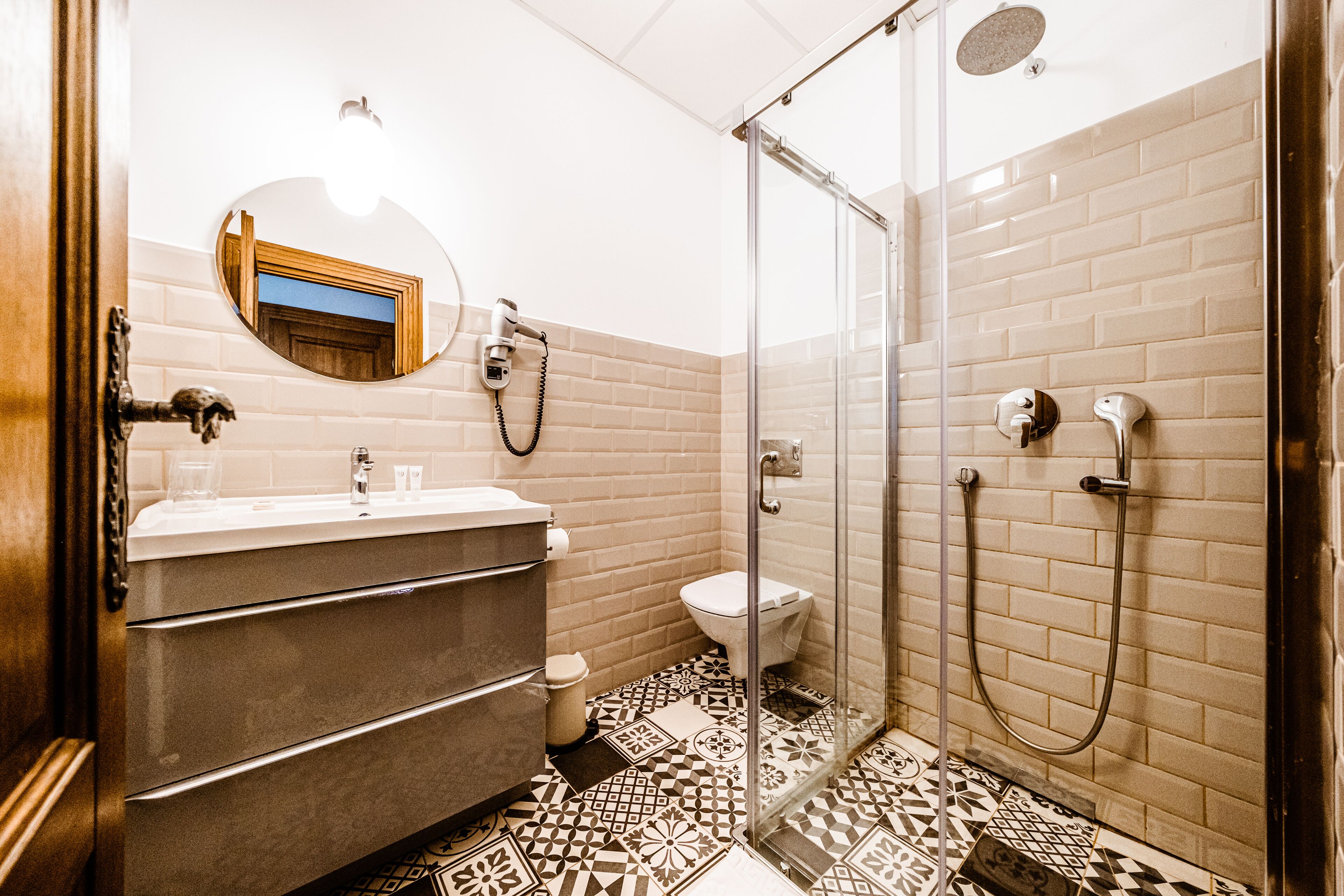 A bathroom with a shower, toilet, and sink.