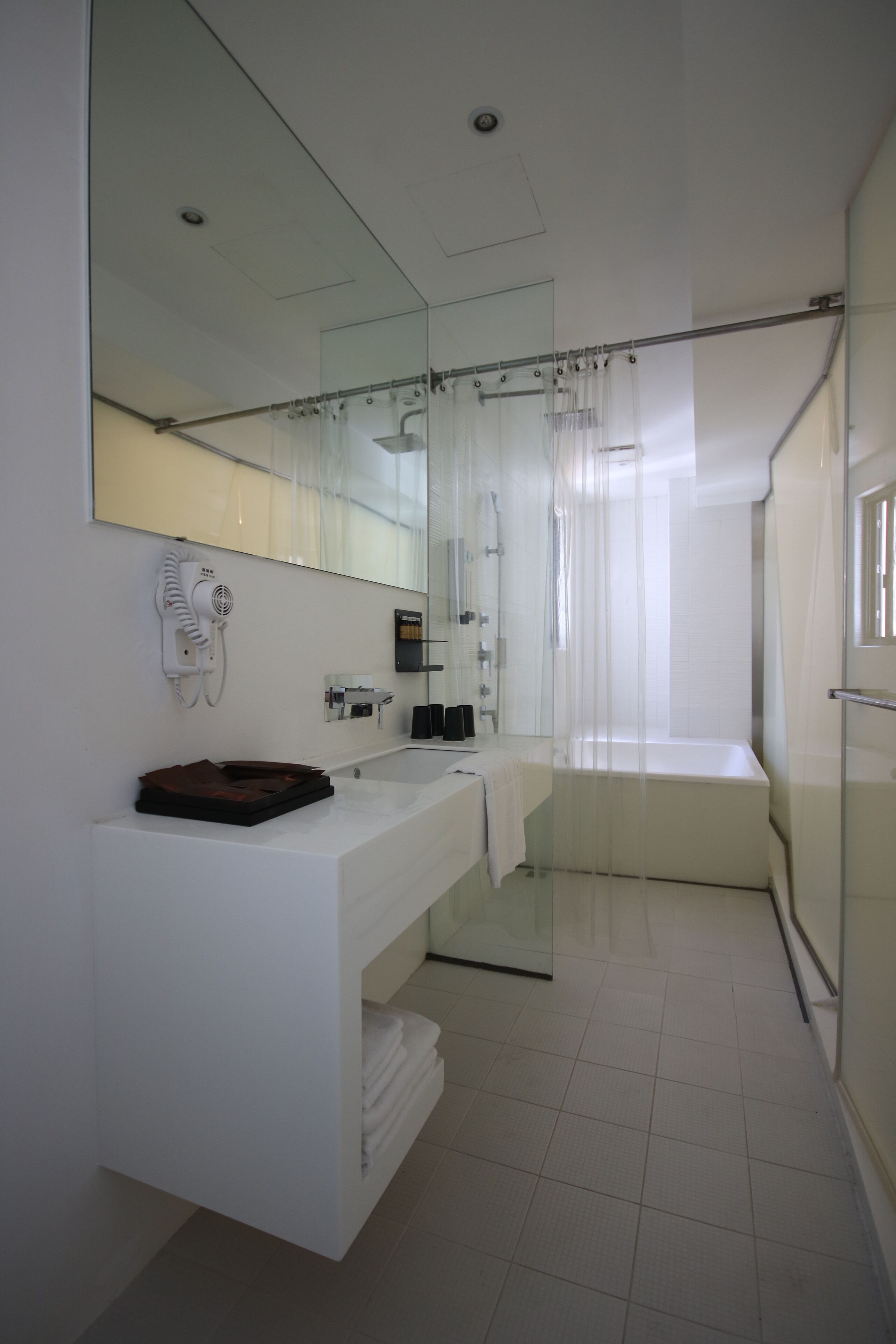 shower, hair dryer, slippers, towels