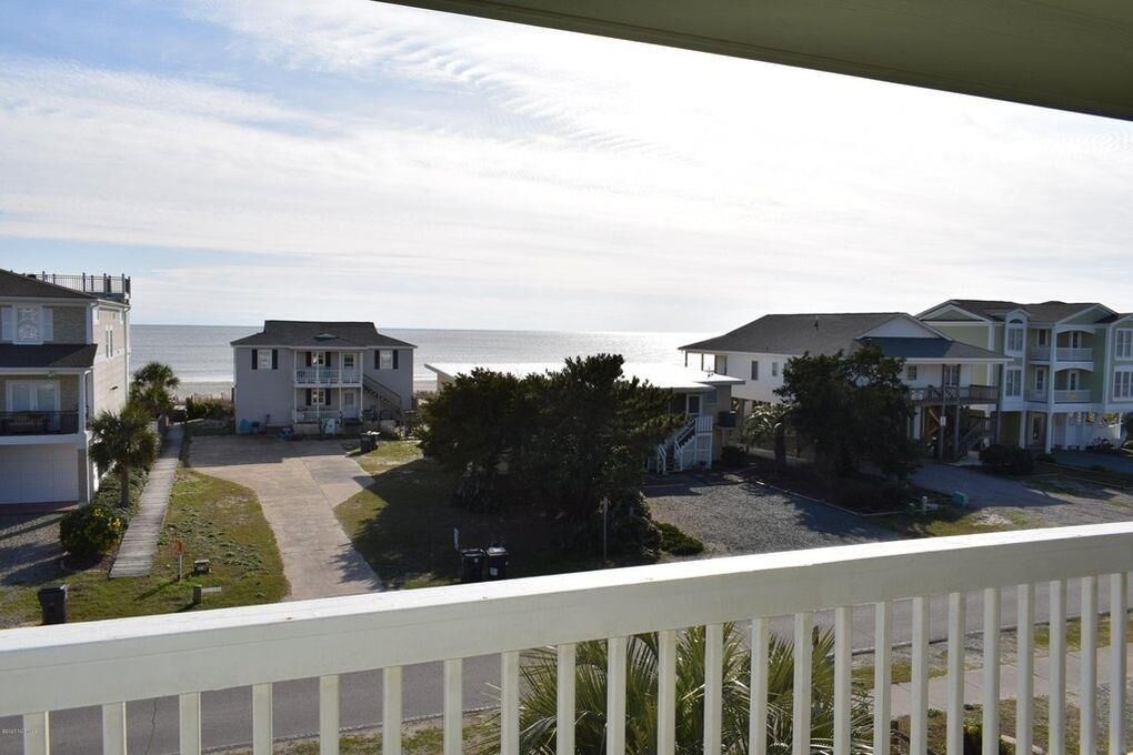 A coastal residential area with houses and a view of the ocean.