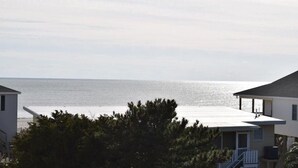 A coastal view with a house and a beach in the background.