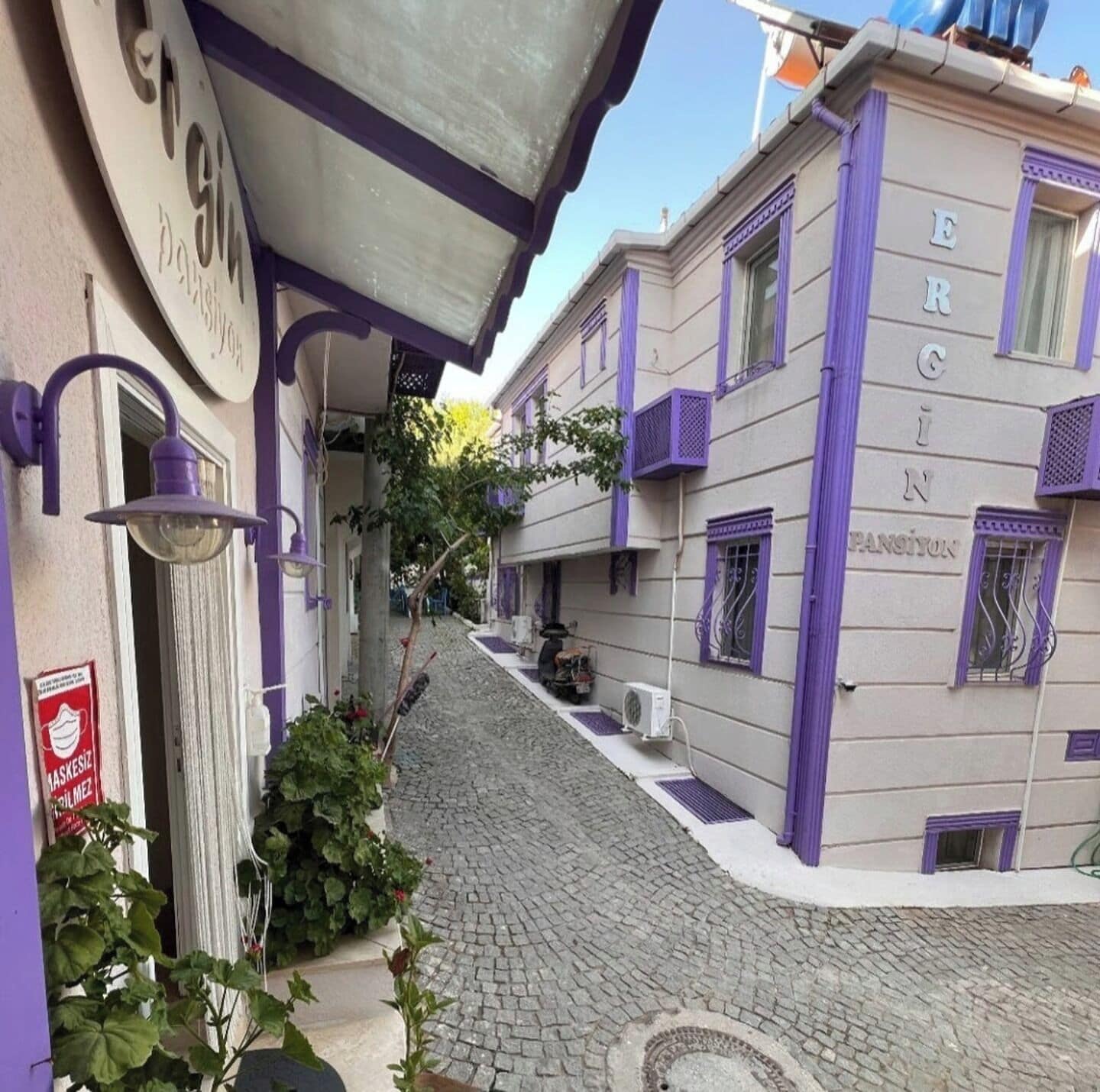 A narrow cobblestone street with buildings on either side.