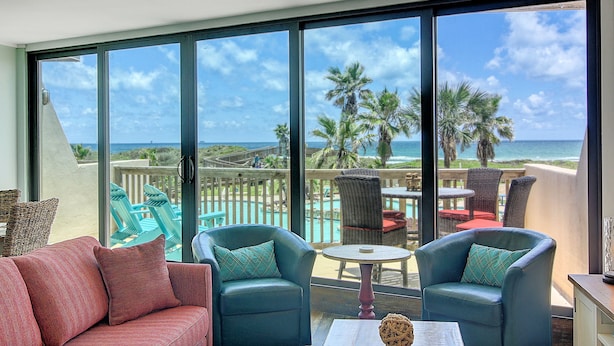 A balcony with a view of the ocean, furnished with two armchairs and a small table. - Escape to Mayan Princess 213 Beachfront Getaway! (Port Aransas)