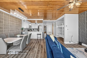 A modern interior with a dining area, kitchen, and living space.