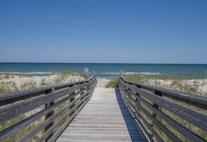 A wooden boardwalk leading to a beach with clear skies. - Spectacular Oceanfront Condo with Ocean Views, Community Pool and Beach Access (Carolina Beach)