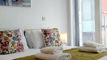 2 habitaciones, escritorio y tabla de planchar con plancha