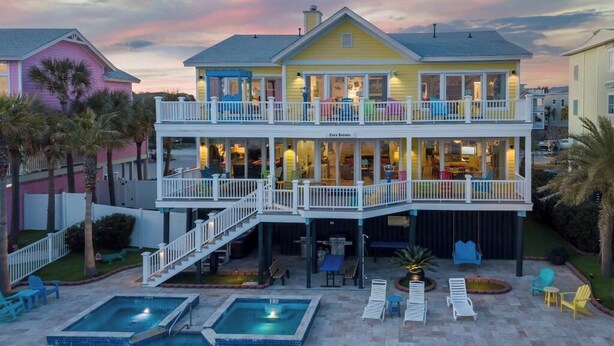 A two-story building with a balcony, a pool, and outdoor seating. - Casa Banana Oceanfront on Ocean Blvd, 6 BD, sleeps 20, pool,hot tub, elevator (Isle Of Palms)
