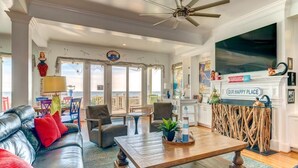 A spacious living room with a leather sofa, a wooden coffee table, and a fireplace. - Casa Banana Oceanfront on Ocean Blvd, 6 BD, sleeps 20, pool,hot tub, elevator (Isle Of Palms)