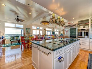 Enjoy cooking in this well-equipped kitchen with a large island, sink, and modern appliances.